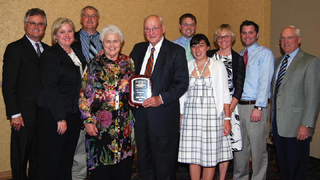 The family of John Owen, Watertown, was on hand to celebrate John's induction into the South Dakota Auctioneers Hall of Fame. Holding the plaque is John with his wife, Beverly at left. 