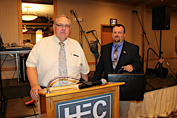 Wayne Bessman presenting 2018-2019 SDAA President Ken Girard the traveling briefcase in memory or Warren Bessman